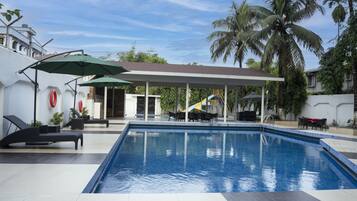 2 outdoor pools, open 6 AM to 8 PM, pool umbrellas, pool loungers