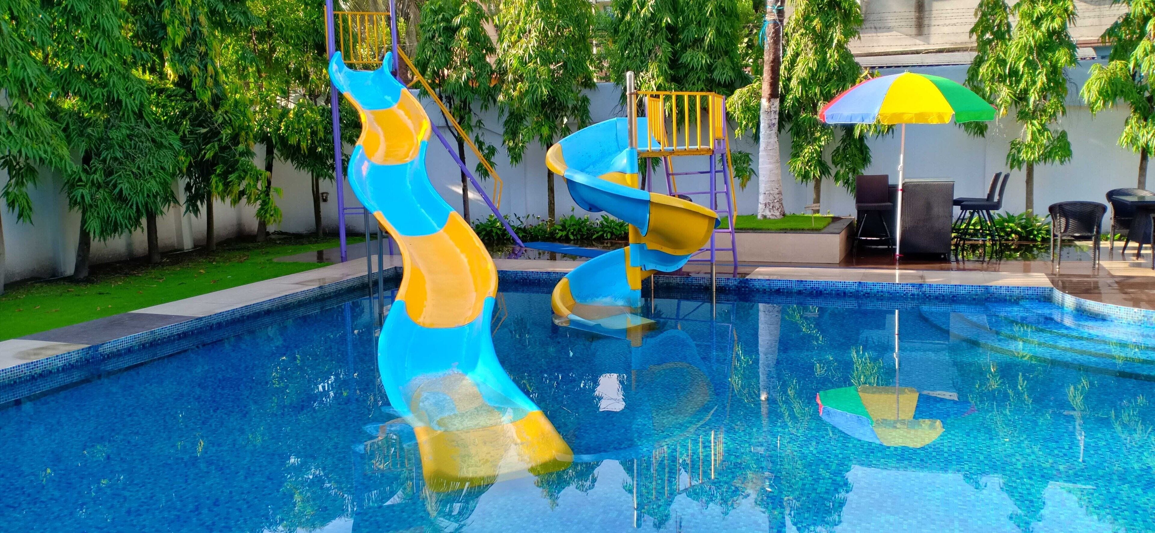 2 outdoor pools, open 6 AM to 8 PM, pool umbrellas, pool loungers