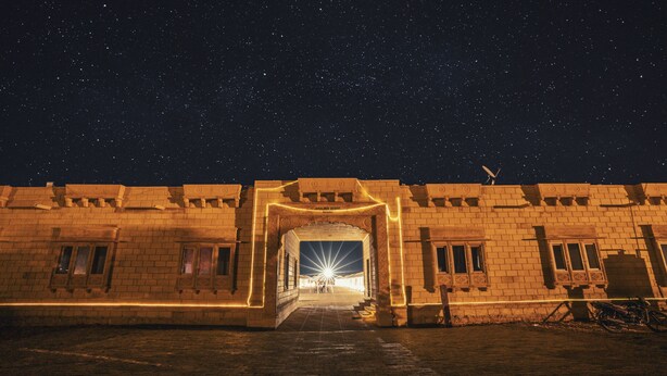 An entrance to a building with a starry night sky above. - Dynasty Desert Camp (Jaisalmer)