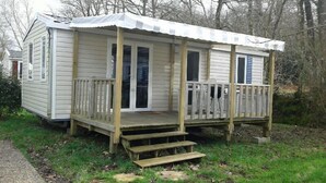A small, single-story cabin with a porch and a covered entryway.