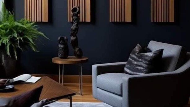 A modern living room with a dark blue wall, a grey sofa, a wooden coffee table, and a small side table with a plant.