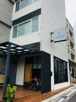 A modern building with a signboard reading "Love Travel B&B".
