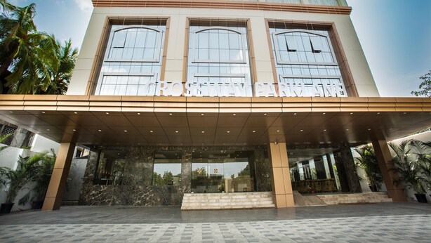 A modern building with a large entrance, large windows, and a sign reading "GROSVENY PARK". - St Parklane Airport Hotel Chennai (Chennai)