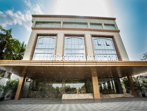 Un edificio moderno con una entrada amplia, grandes ventanales y un cartel que dice "GROSVENY PARK".