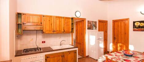 Réfrigérateur, un four, surface de cuisson, vaisselle et ustensiles