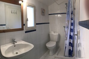 Bathtub, hair dryer, soap, toilet paper