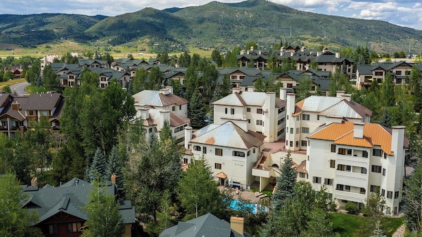A residential area with multiple houses and a large building with a swimming pool.