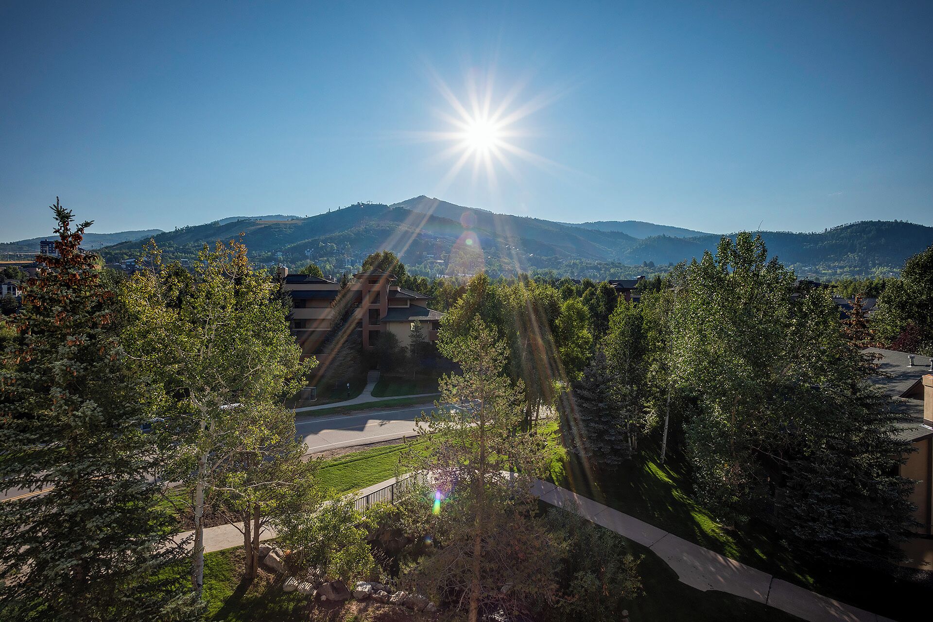 A residential area with a clear view of a mountain range in the background.