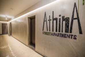 A hallway with a sign for 'Athina Street Apartments'. - AthinA STREETAPARTMENTS (Athens)