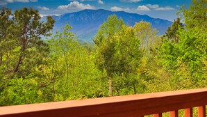 A mountain landscape with a clear sky and trees in the foreground. - Gatlinburg Log Cabin, Amazing Views Hot Tub, Theater Room, Internet Free Tickets (Gatlinburg)