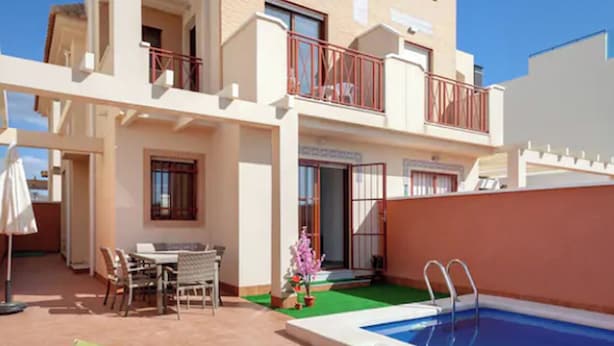 A two-story building with a swimming pool, outdoor seating, and a small garden. - Flagship Private Villa 3bed + pool - sleeps 6 Mazarron (FREE WIFI & Air-con)! (Mazarrón)