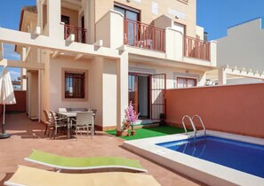 Enjoy outdoor meals and relaxation on the patio and by the pool.