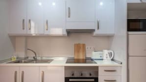 A compact kitchen with white cabinets, a stainless steel sink, a toaster, and an oven. - Flagship Private Villa 3bed + pool - sleeps 6 Mazarron (FREE WIFI & Air-con)! (Mazarrón)