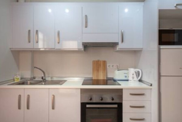 Enjoy cooking in this well-equipped kitchen with an oven, stainless steel sink, and ample countertop space.