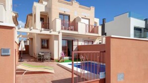 A two-story residential building with a swimming pool, a covered patio, and a gated entrance. - Flagship Private Villa 3bed + pool - sleeps 6 Mazarron (FREE WIFI & Air-con)! (Mazarrón)