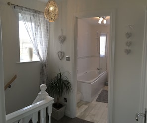Combined shower/tub, hair dryer, towels, soap