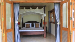A wooden four-poster bed with a canopy, two nightstands, and a tiled floor. - Ume Cantik Villa (Sukasada)