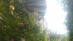 A paved outdoor area with a pergola, potted plants, and a seating area. - Hotel Illi  (Massa)
