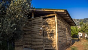 A wooden cabin with a sloped roof and a small porch.