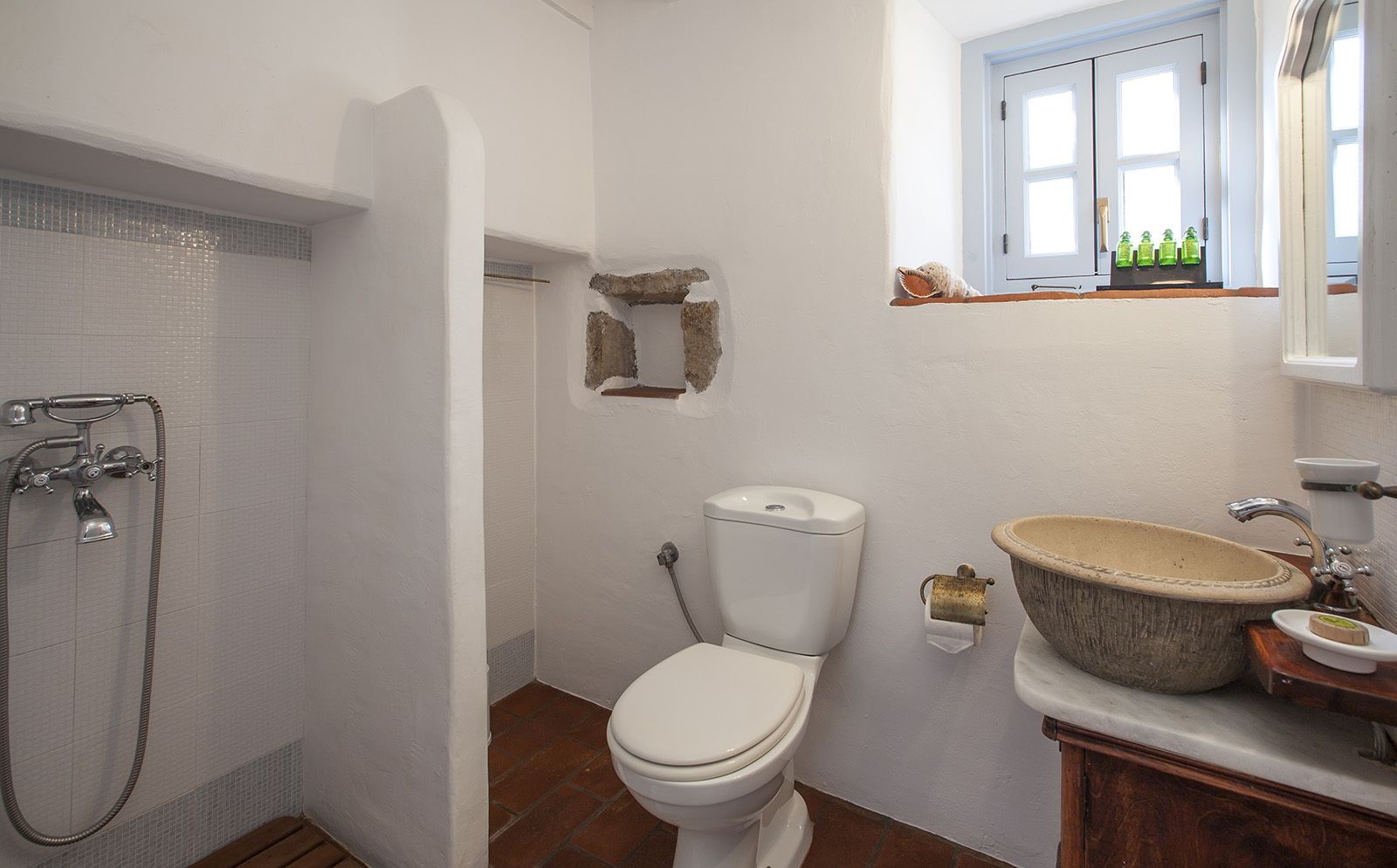 A bathroom with a shower, toilet, and sink.