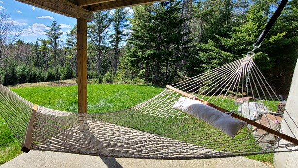 A hammock under a wooden pergola in a grassy area with trees in the background. - A spacious sanctuary with 10+ private acres a few miles from Acadia NP entrance (Bar Harbor)