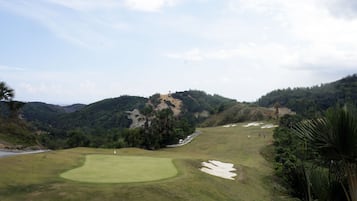 Enjoy a round of golf amidst lush greenery and rolling hills.