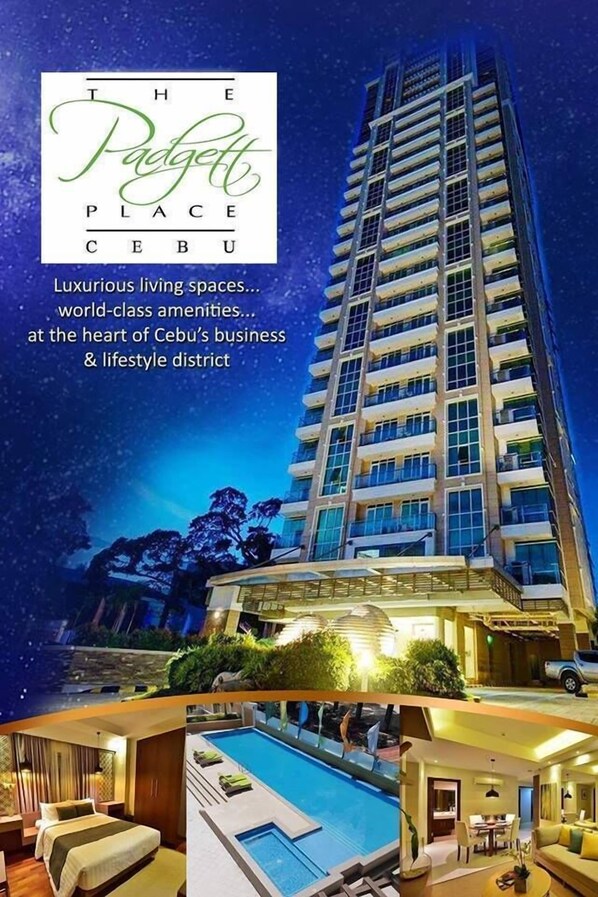 A high-rise building with multiple balconies, a swimming pool, and a well-lit exterior. - Padgett Place - Deluxe Suites (Cebu City)