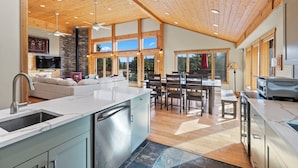 A spacious kitchen with a central island, wooden ceiling, and large windows. - Spectacular Peak 7 Open and Great Views! STR21-01365 (Breckenridge)