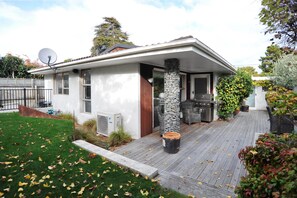 A modern house with a patio, a stone pillar, and a satellite dish. - Leinster Villa (Christchurch)
