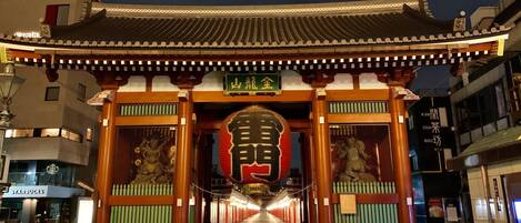 A traditional Japanese gate with a sign above it.