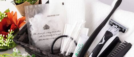 A bathroom vanity with a white towel, a black comb, a white toothbrush, and a shower cap.