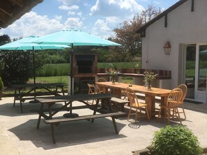 Enjoy al fresco dining on the patio with a barbecue grill and comfortable seating.