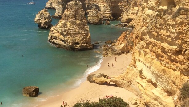 A coastal landscape with rocky cliffs, a sandy beach, and clear blue waters. - Beautiful new two bedroom apartment in Albufeira, Algarve<br> (Albufeira)