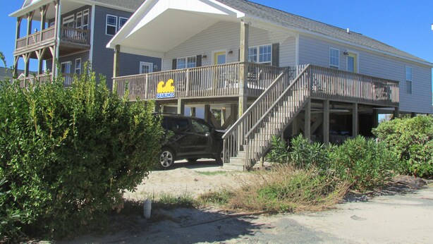 A two-story building with a covered porch and a sign for 'Seablings'. - Enjoy an uncrowded beach, but close to shopping and restaurants. (Surf City)