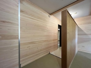 A modern interior with wooden panel walls and a visible door leading to another room.