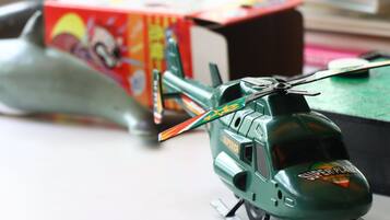 A toy helicopter and a toy submarine on a table.
