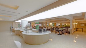 A modern hotel lobby with a central reception desk, seating area, and a large window providing natural light. - Echarm Hotel Shanghai Hongqiao Airport (Shanghai)