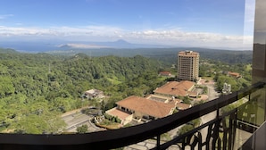 A high-rise building with a view of a residential area and distant mountains. - Splendido Tower 2 Ann's Unit  (Laurel)
