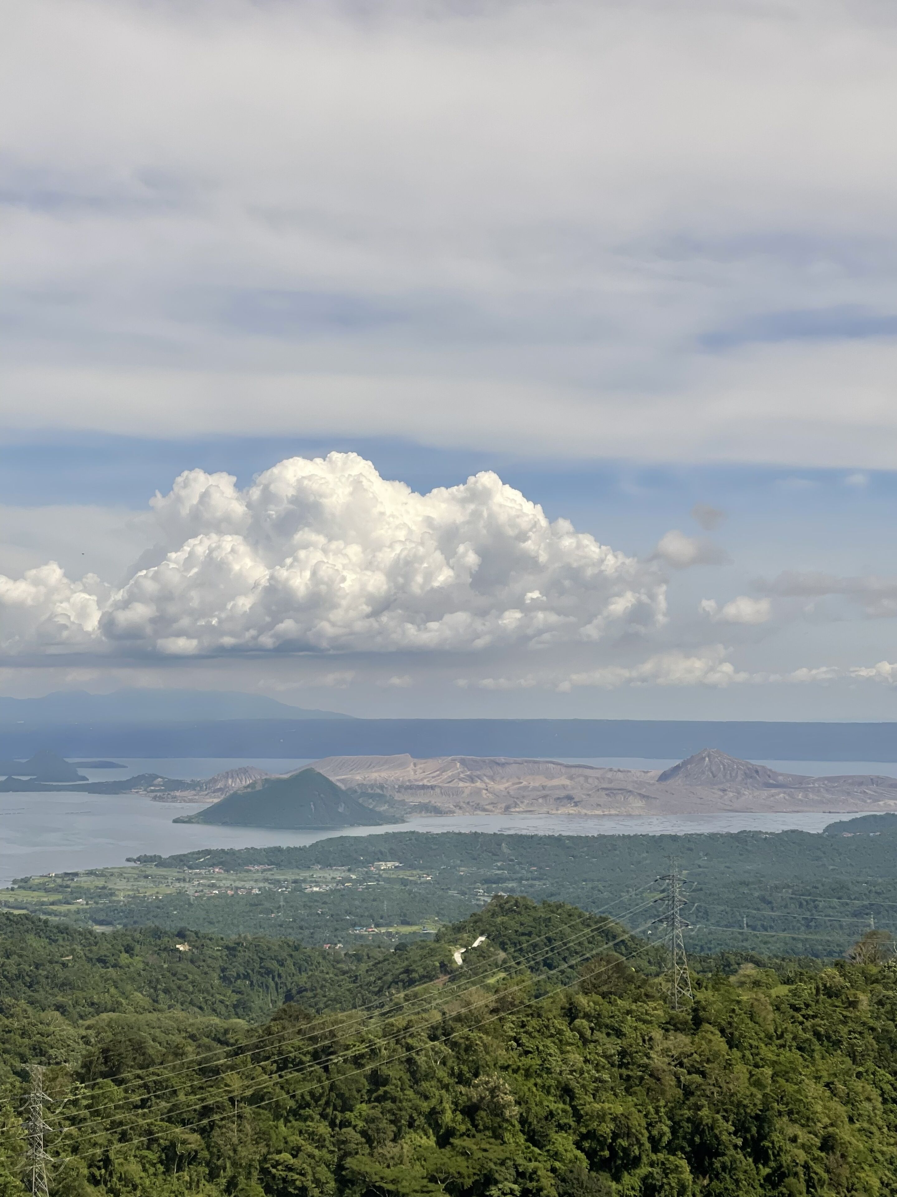 A mountainous landscape with a large cloud formation.