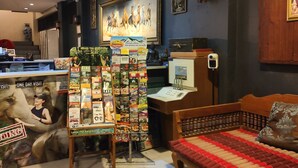 A room with a bed, a desk, and a wall-mounted TV. There is a poster on the wall and a small statue on the desk. - Panda House Chiang Mai (Chiang Mai)