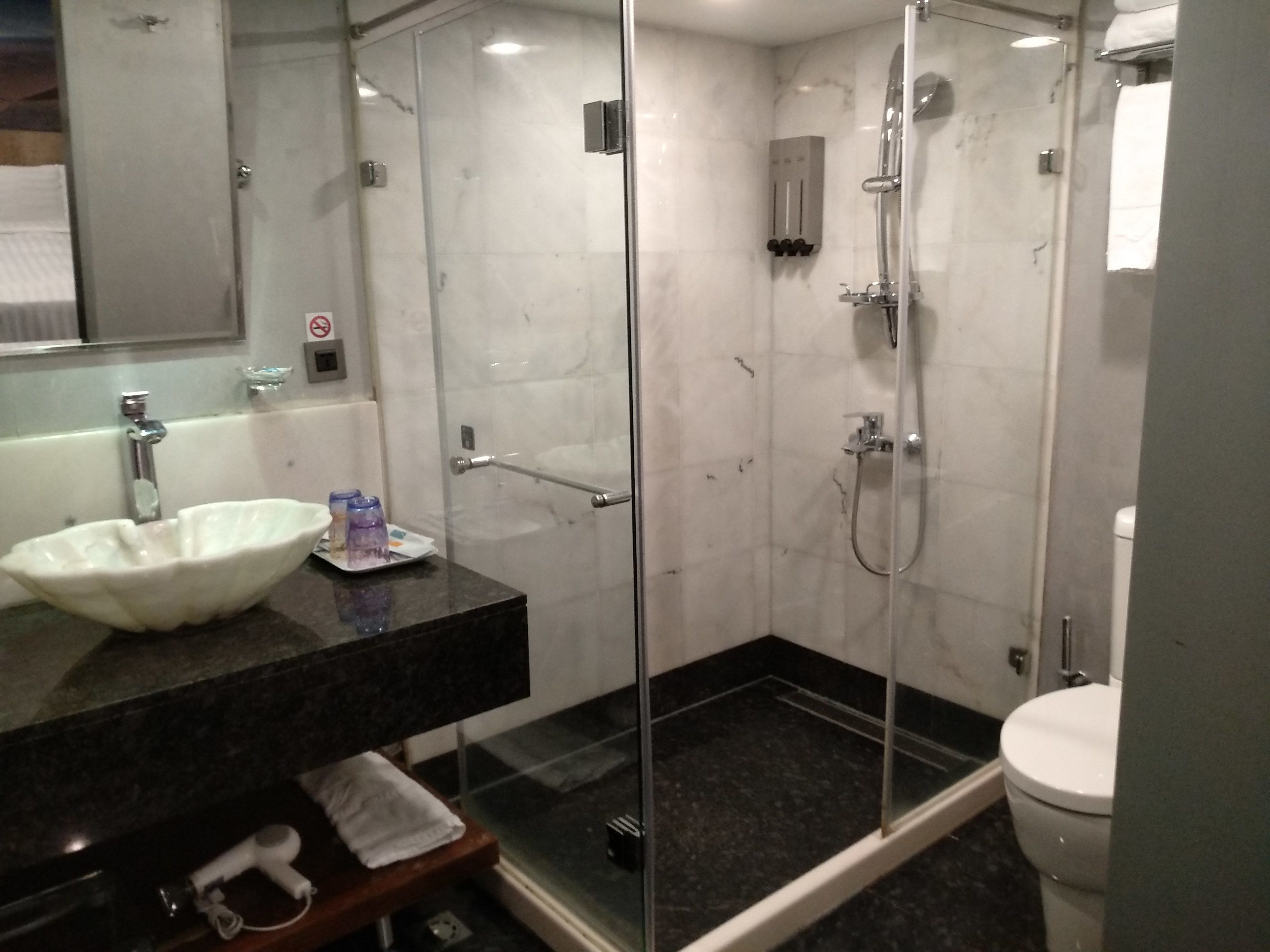 deluxe quadruple room, 2 double beds, tower | bathroom | shower, rainfall showerhead, hair dryer, towels