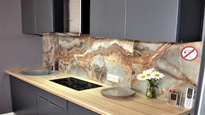 A modern kitchen with two sinks, a marble backsplash, and a wooden countertop. - Kyiv City Center (Kyiv)