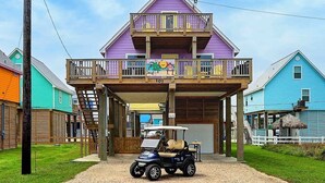 A two-story building with a balcony, a sign reading "Subway Paradise," and a golf cart parked in front. - 🌴Surfside Paradise#3-amazing views,golfcart🌴 (Surfside Beach)