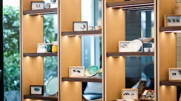 A modern interior with wooden shelves displaying various items like framed certificates, decorative plates, and small bowls.