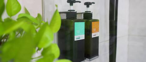 A bathroom with two hand sanitizer dispensers mounted on a wall.