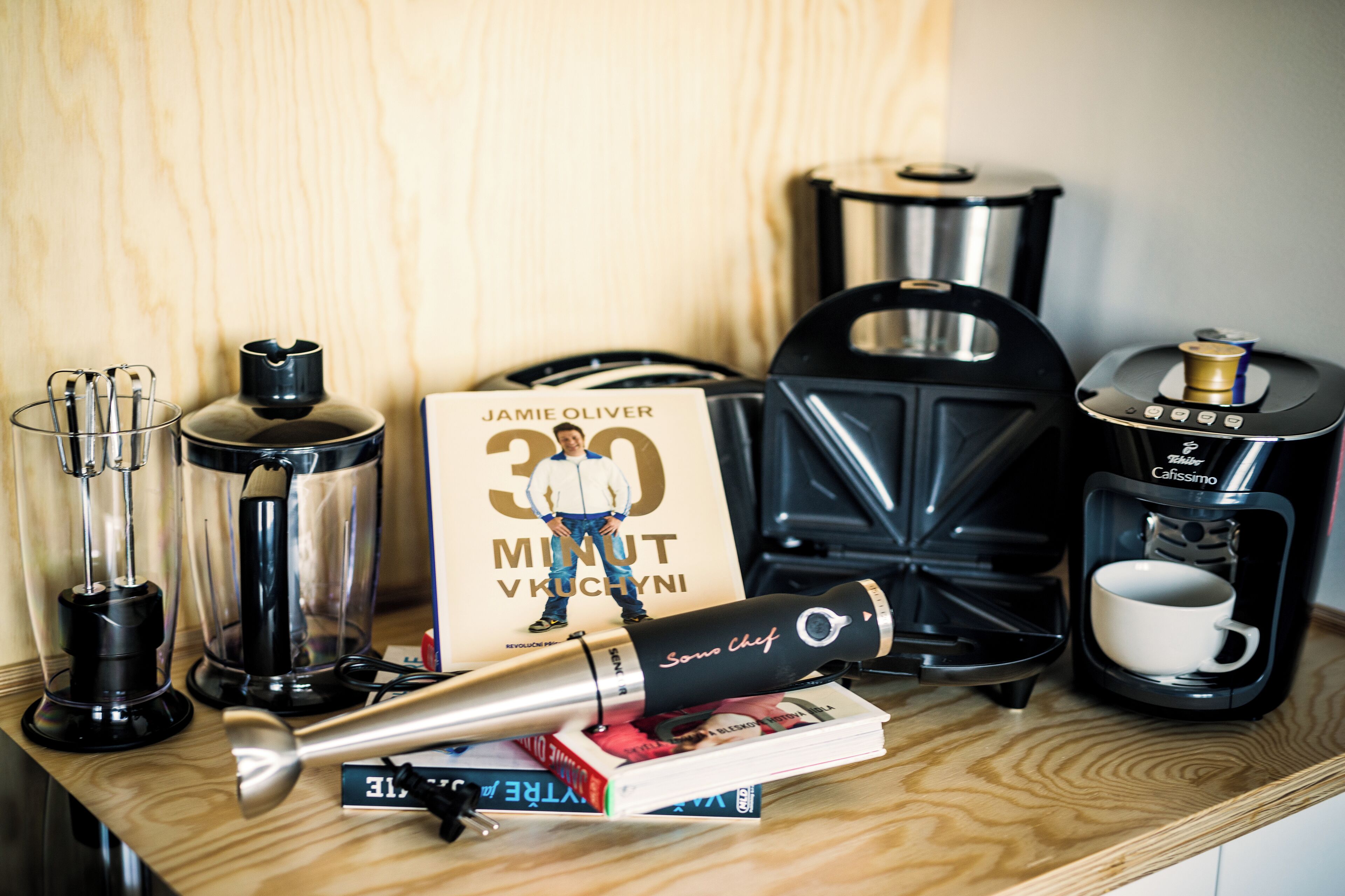 A kitchen counter with various appliances including a coffee maker, a blender, and a toaster.