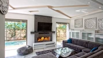 Luxury Villa, Pool View (3 Suites Luxe) | Living room | 32-inch flat-screen TV with cable channels, TV, fireplace