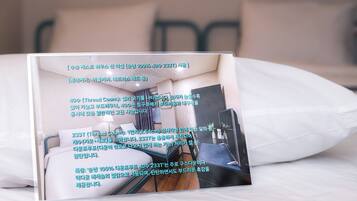 A brochure of a hotel room with a bed, a desk, and a chair.