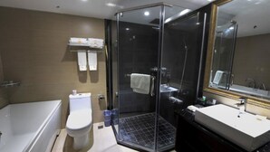A modern bathroom with a glass-enclosed shower, a white toilet, and a sink with a large mirror. - Panda Prince Hotel Suining Branch (Suining)