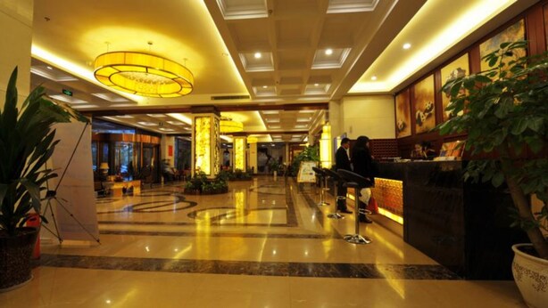 A hotel lobby with a reception desk, seating area, and a large chandelier. - Panda Prince Hotel Suining Branch (Suining)
